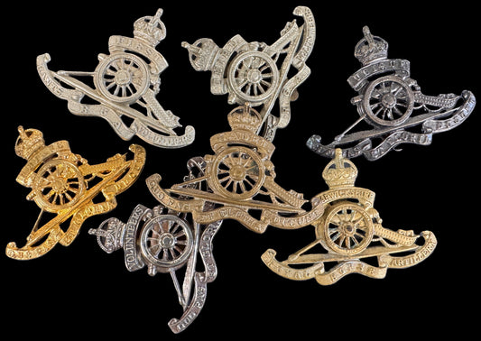 A selection of fake Royal Artillery cap badges.