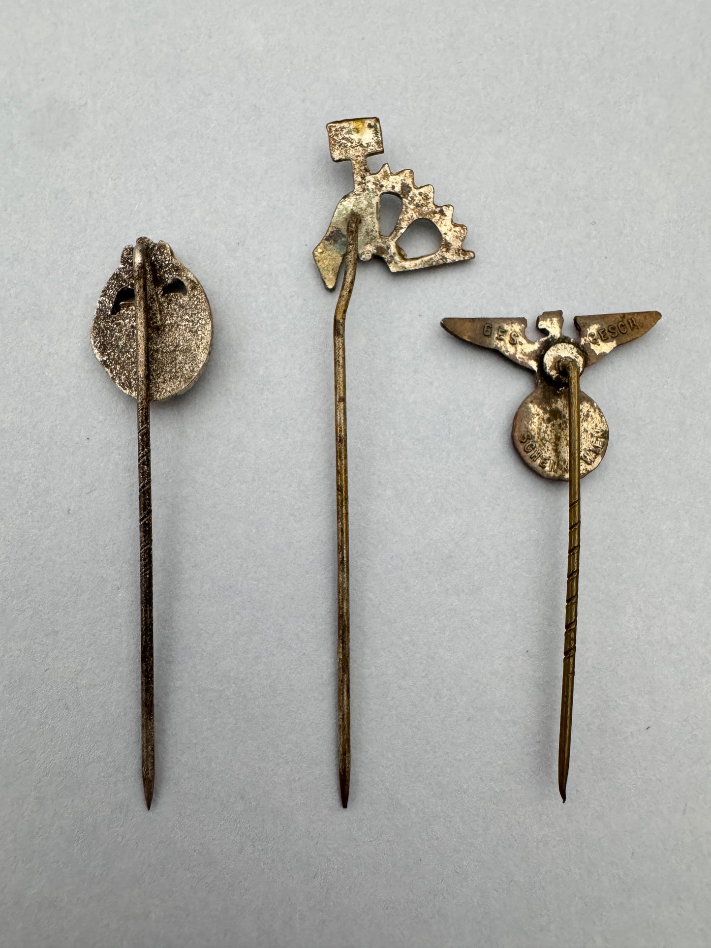 WW2 German Panzer Assault Badge & Other Stickpins – A trio of original stickpin miniature badges. A Panzer Assault Badge i...