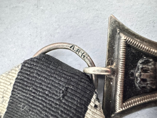 a maker mark stamp in the mount ring of a german iron cross medal