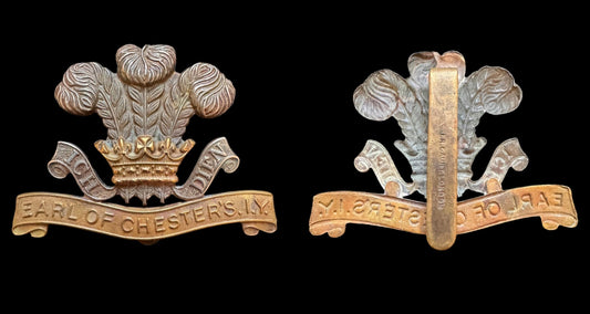A front and reverse view of a fake earl of chester imperial yeomanry cap badge on a black background.