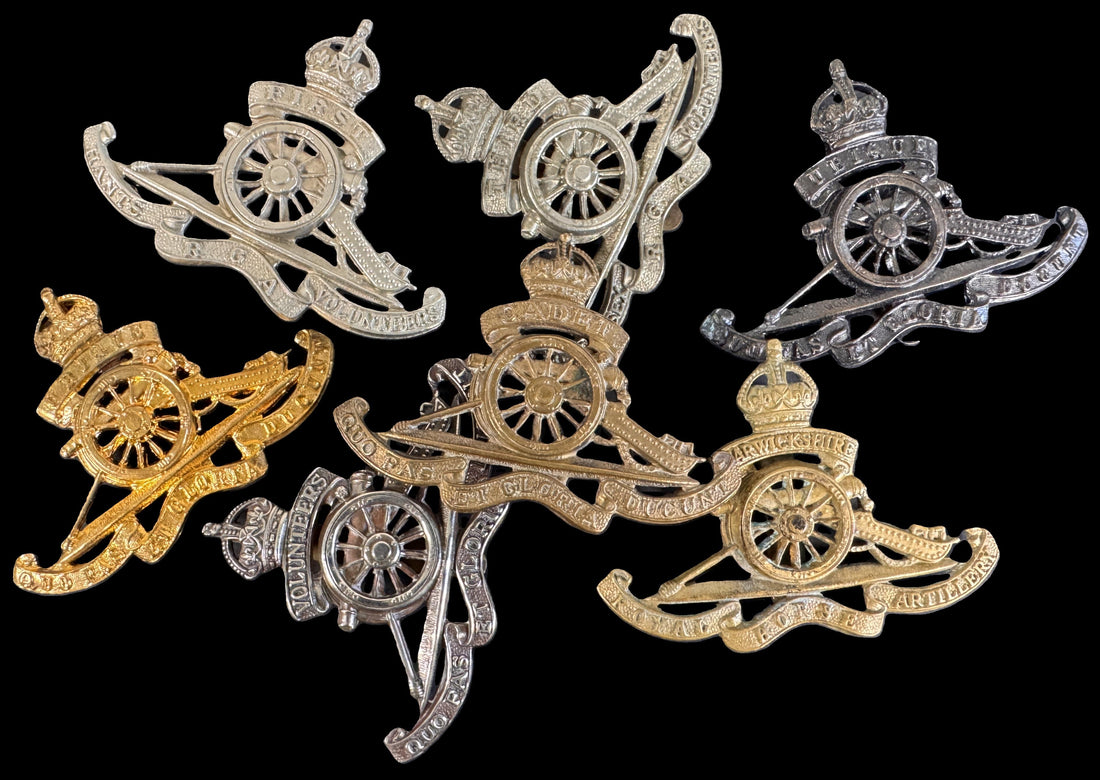 A selection of fake Royal Artillery cap badges.