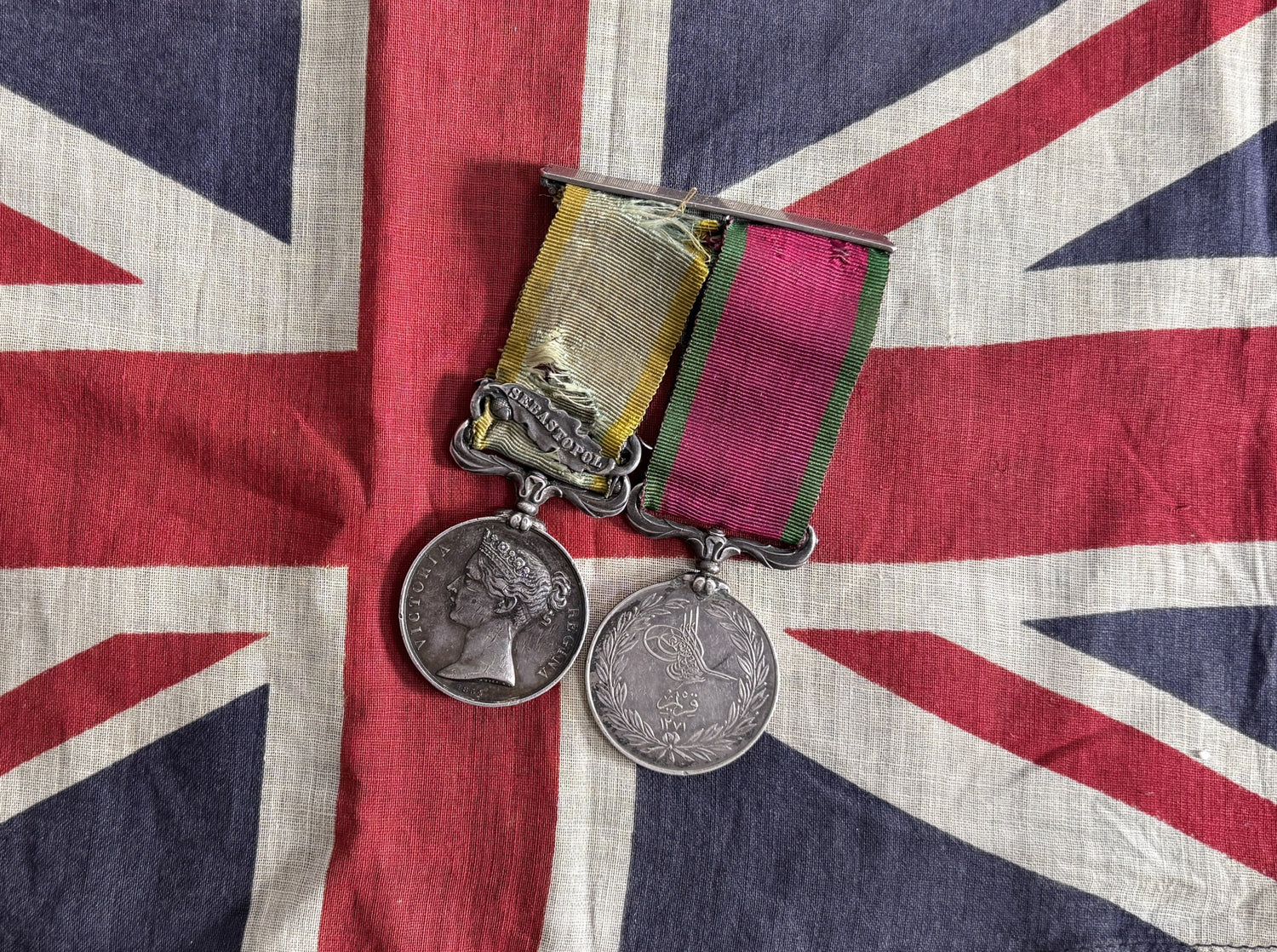 Abtique British Crimea War medals on a Union Jack background.