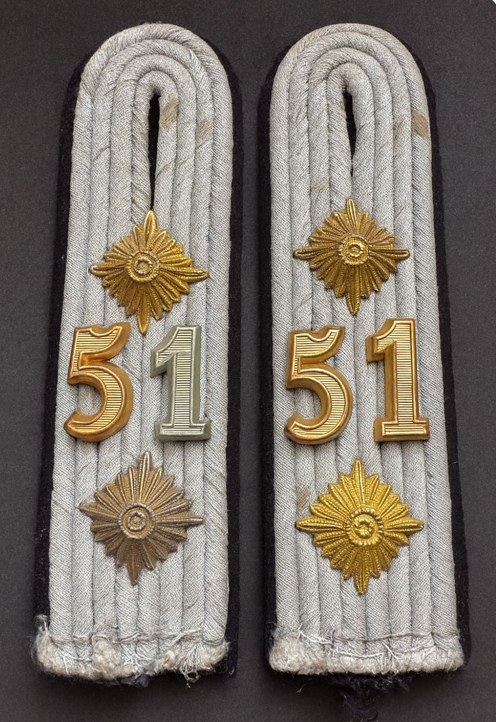 A matched pair of WW2 German Army officer shoulder boards for the 51st Pioneer Battalion, with rank pips and unit numbers on silver braid and wool backing.
