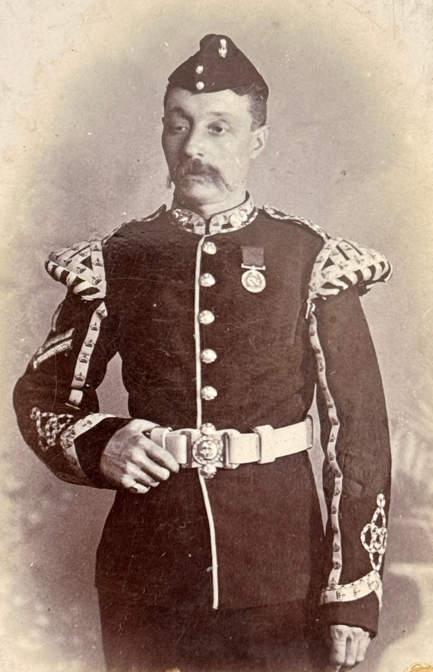 Vintage image of a royal fusiliers piper in full dress uniform and regalia.