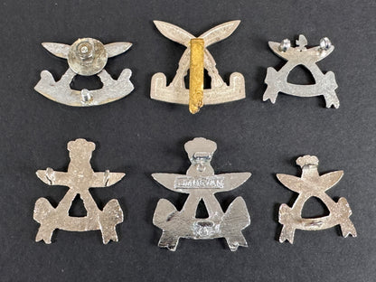 Set of six silver gurkha assam rifles military insignia badges on a dark background