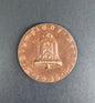 Bronze table medal with embossed design on a gray background. For 9th Olympiad Berlin 1936.