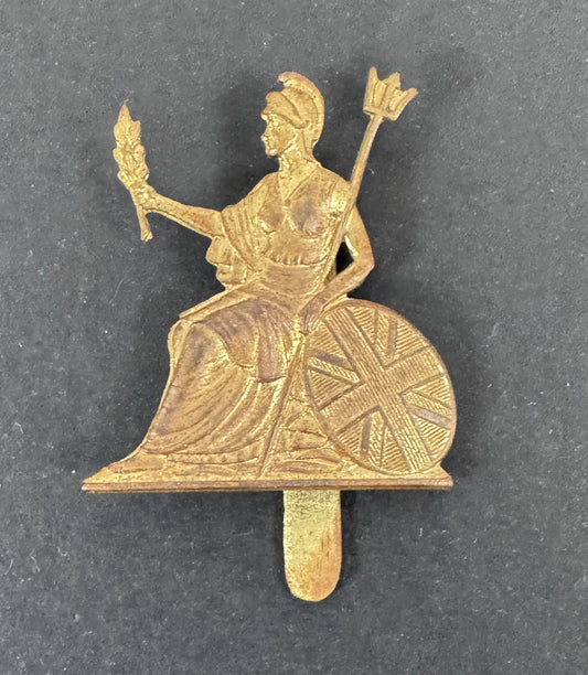 Gold-colored decorative item with a figure on a dark gray background