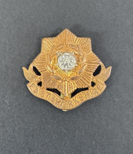 Gold and silver badge on a gray background