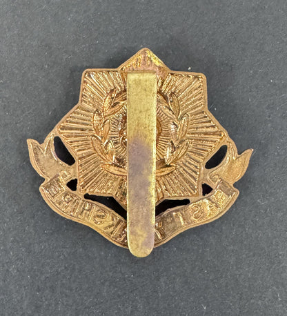Gold military insignia badge on a dark gray background