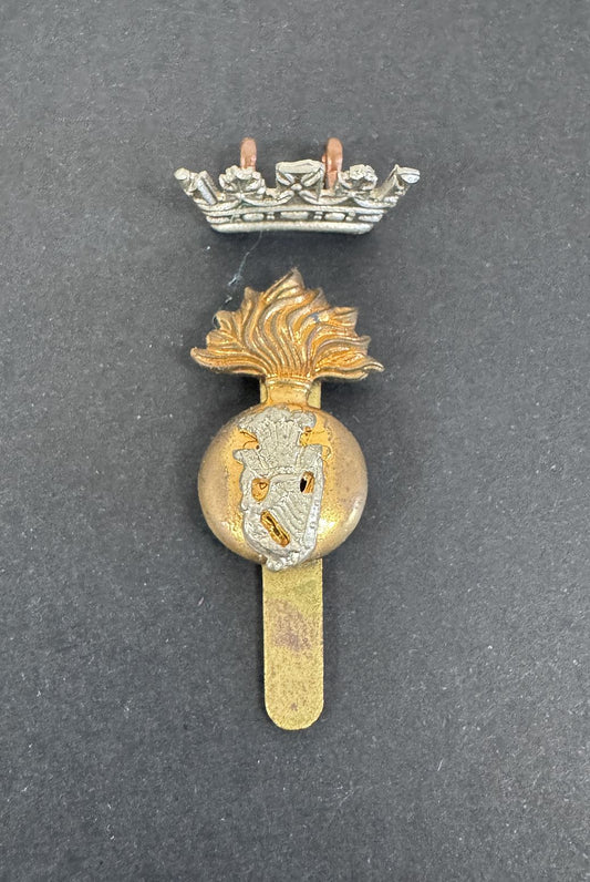 Decorative badge with gold and silver elements on a dark background