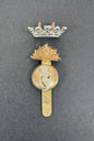 Decorative badge with gold and silver elements on a dark background