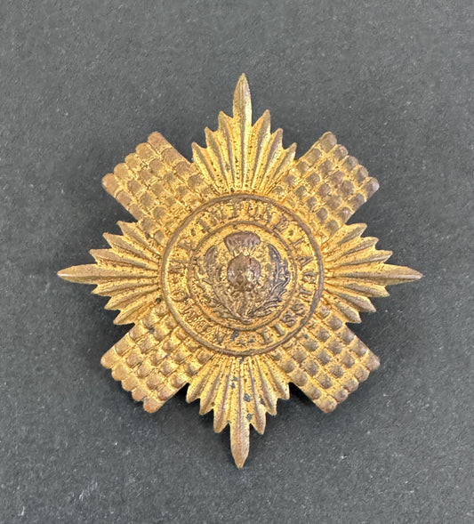 Gold star-shaped military badge on a dark gray background
