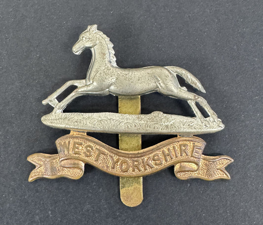 Badge with a horse emblem and 'West Yorkshire' banner on a dark background