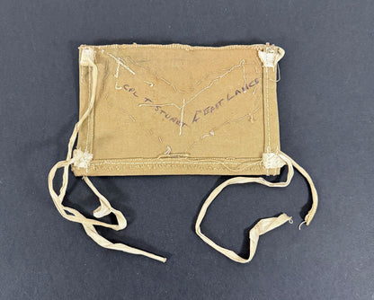 khaki drill fabric brassard with embroidered details on a dark background