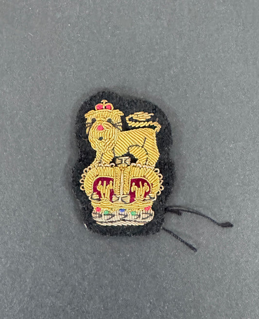 Embroidered patch of a lion and crown on a gray background. brigadier rank of British army.