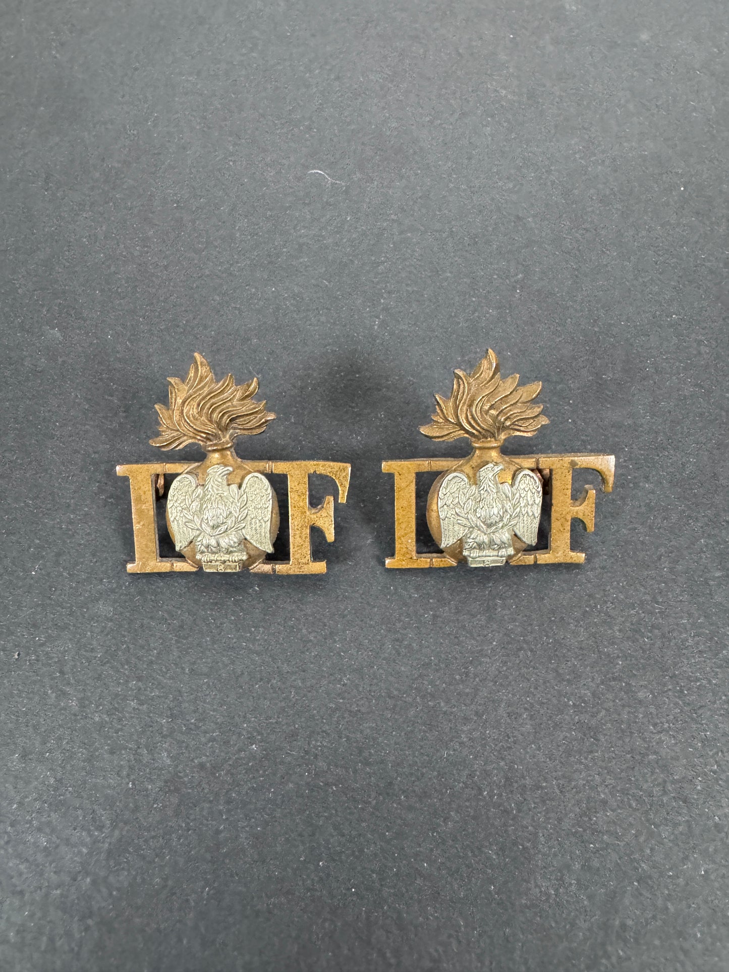 WW2 British Army Irish Fusiliers Shoulder Title Badges (Pair) – A matching pair of original uniform shoulder titles of the...