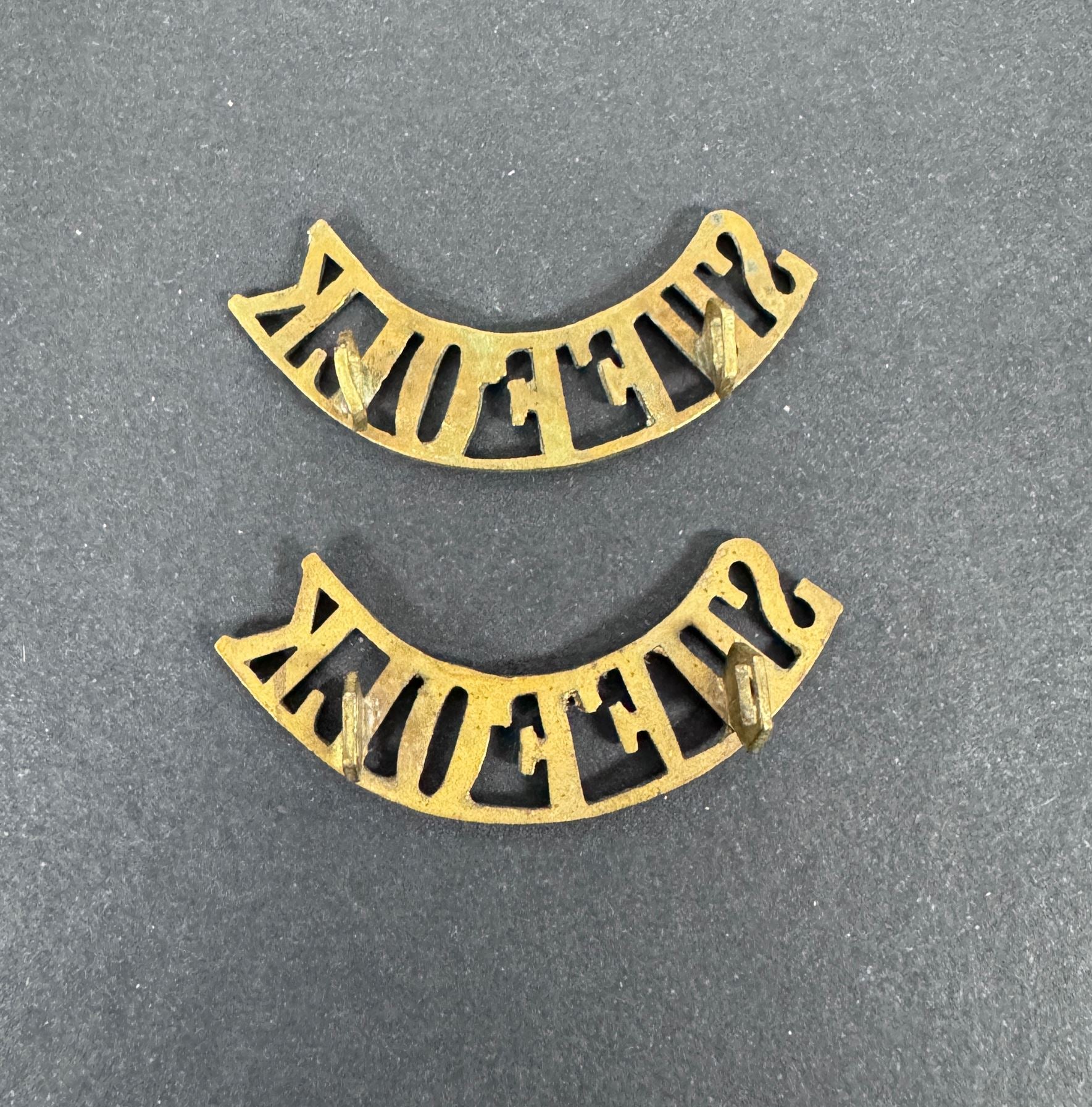British Army Suffolk Regiment Shoulder Title Badges (Pair) – A matching pair of original uniform shoulder titles of the Su...