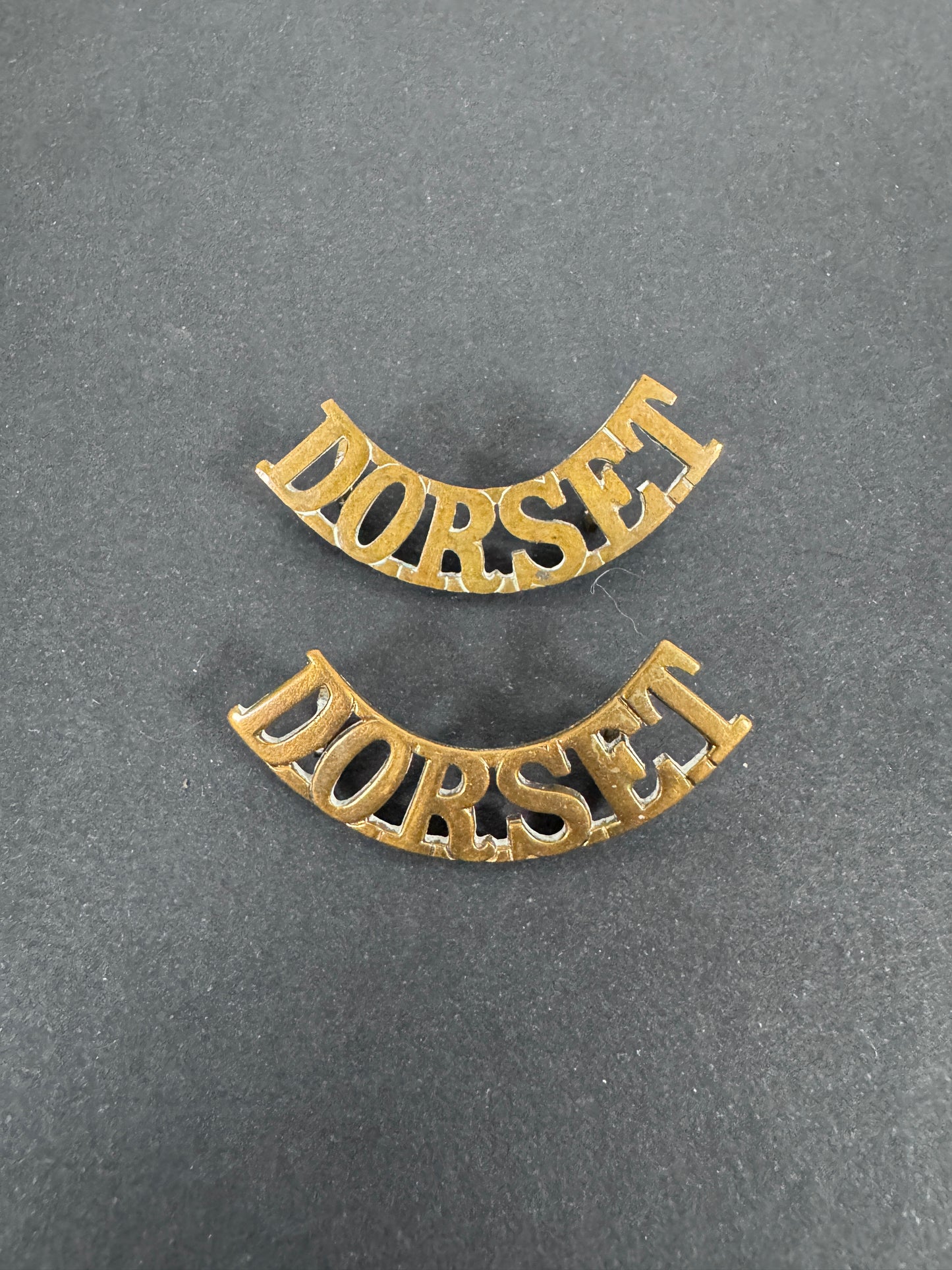 British Army Dorset Regiment Shoulder Title Badges (Pair) – A matching pair of original uniform shoulder titles of the Dor...