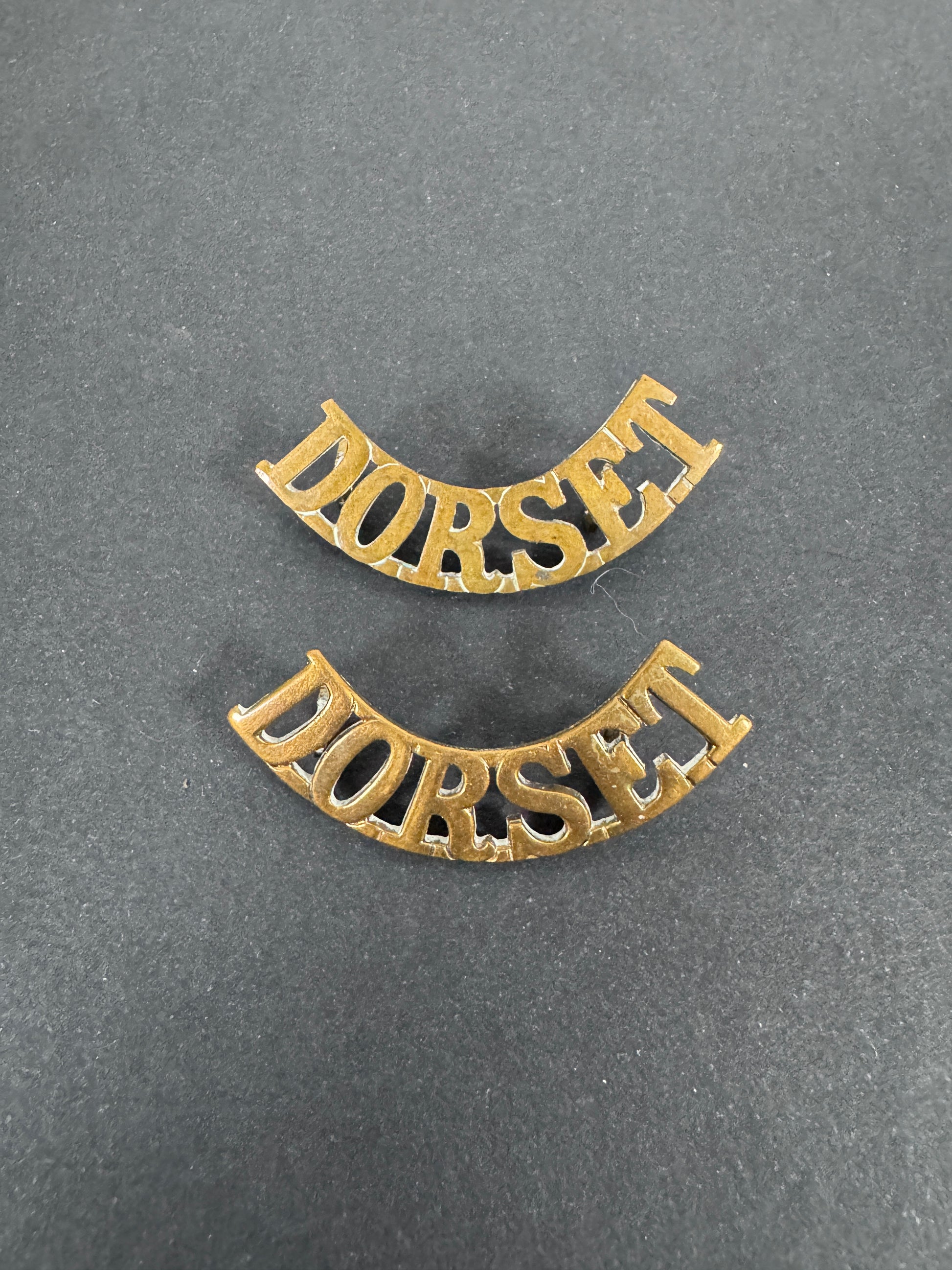 British Army Dorset Regiment Shoulder Title Badges (Pair) – A matching pair of original uniform shoulder titles of the Dor...