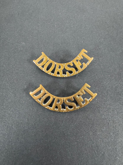 British Army Dorset Regiment Shoulder Title Badges (Pair) – A matching pair of original uniform shoulder titles of the Dor...