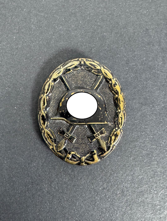 German black wound badge, brass with black painted finish. political symbol blanked out.