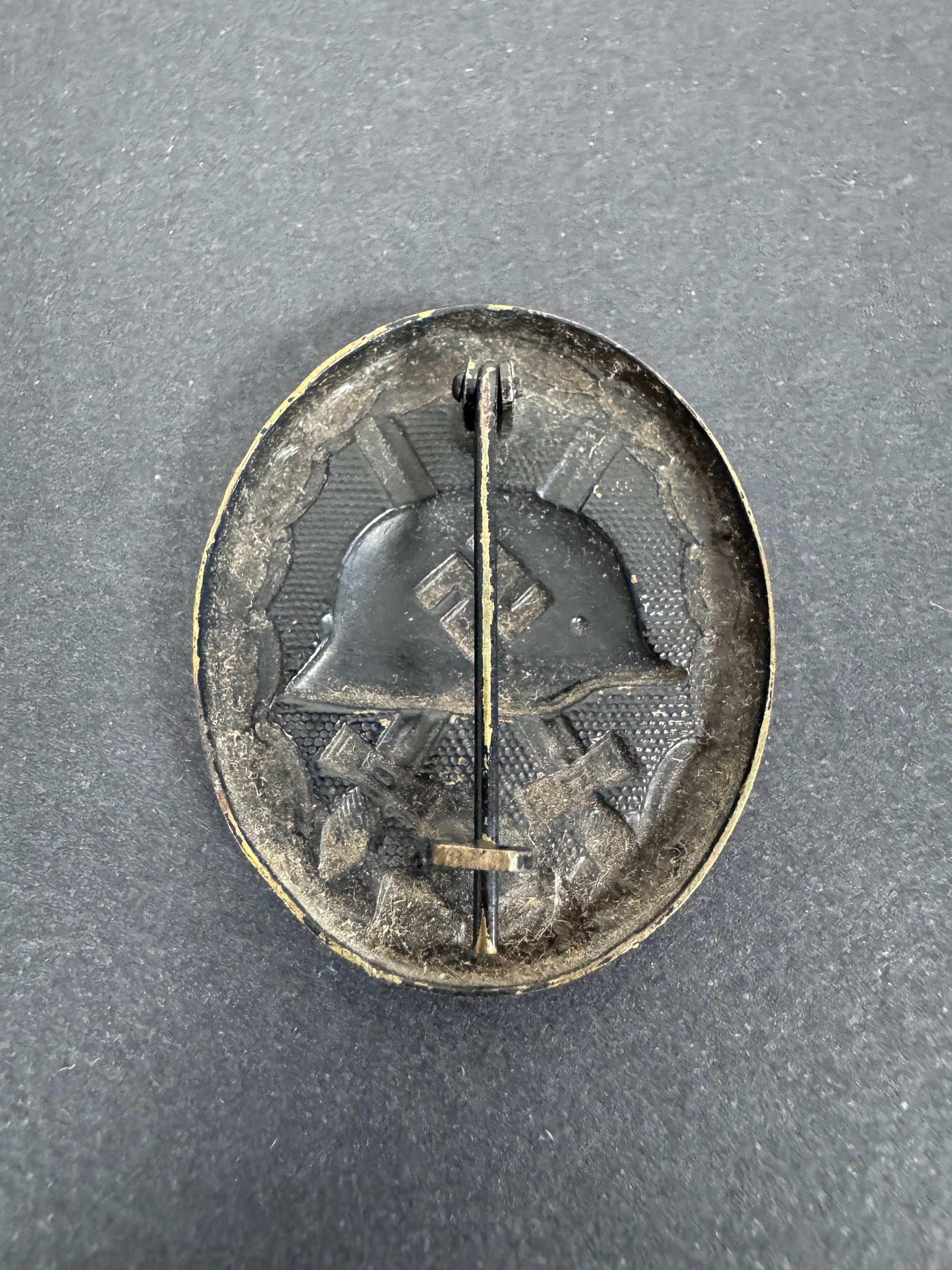 German black wound badge, brass with black painted finish. straight on reverse view.