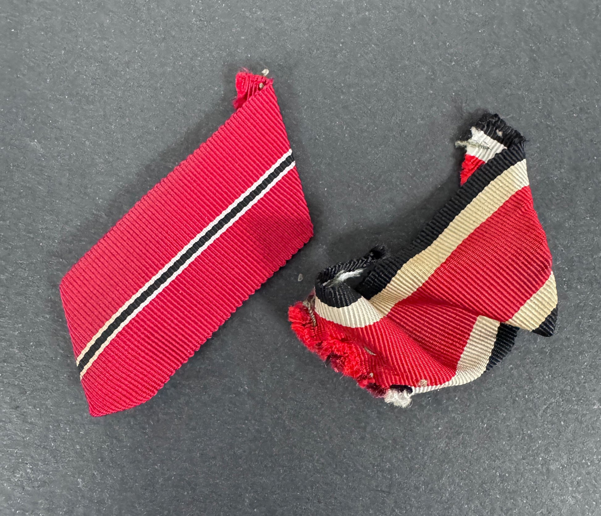 two german ribbons for iron cross and eastern front medal. both in the form as worn and removed from the soldier's tunic.