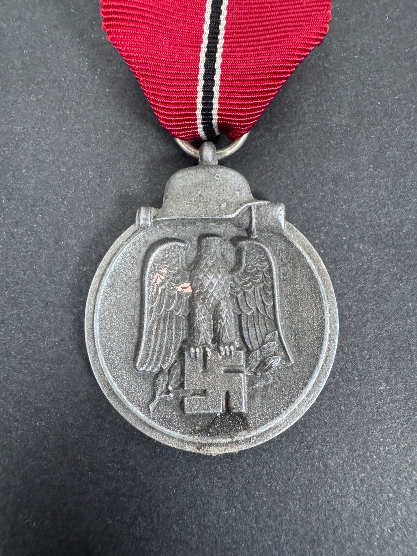 eastern front medal front. zinc. german eagle and political emblem, ribbon.