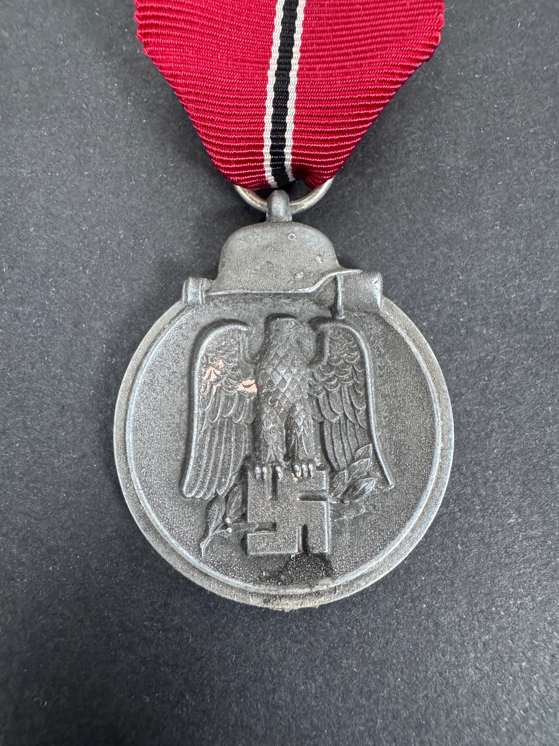eastern front medal front. zinc. german eagle and political emblem, ribbon.