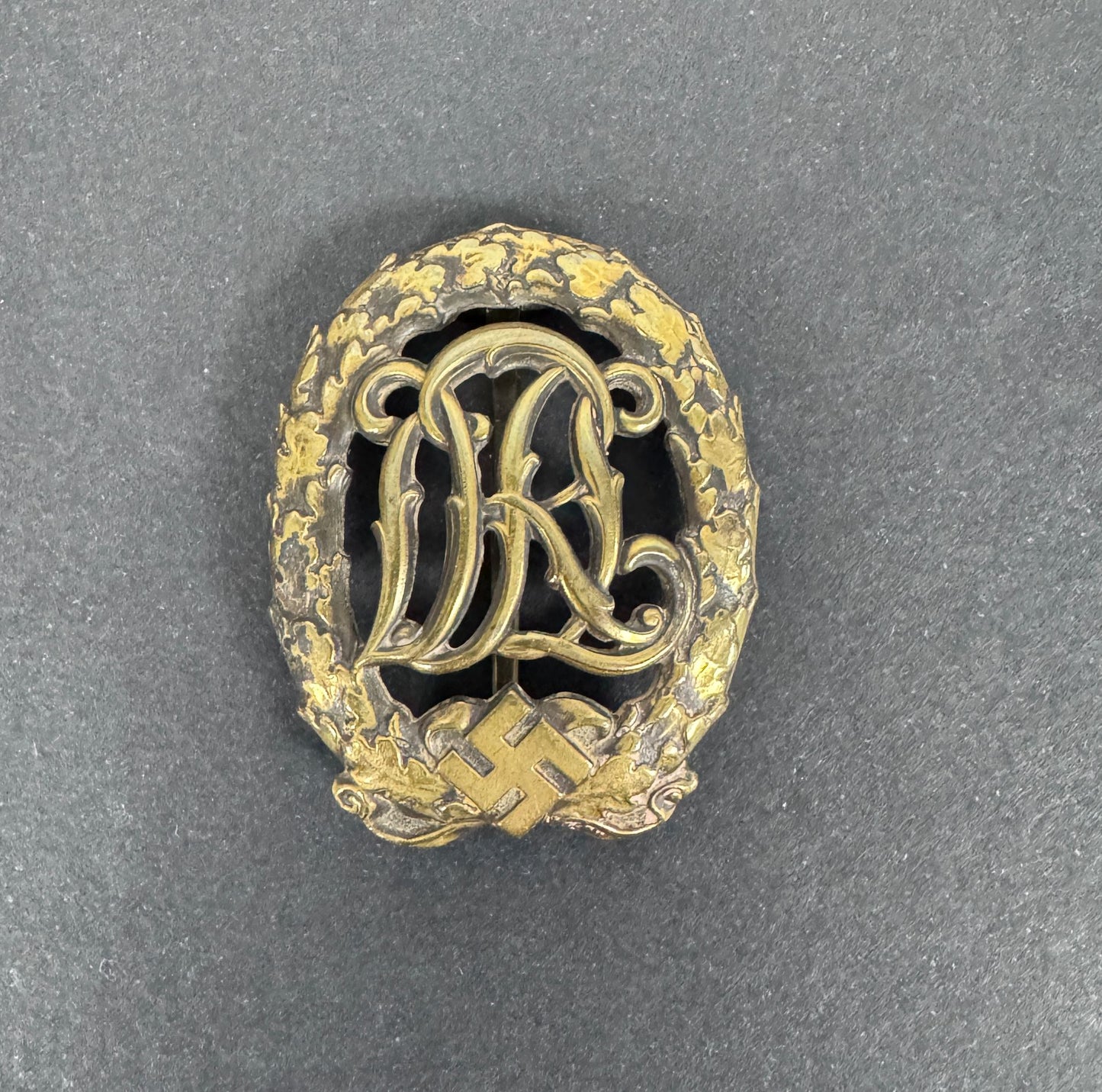 german D R L sports badge in bronze.  tombak and bronze wash finish.