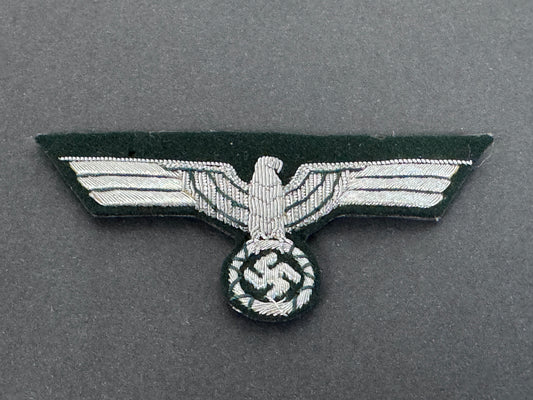 Nazi eagle badge with swastika on a gray background. worn by army officer's on the tunic breast.