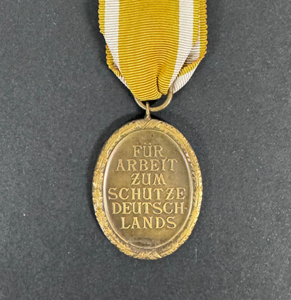 WW2 German Westwall Medal & Issue Packet – A Westwall medal with issue packet and a ribbon bar and device of the