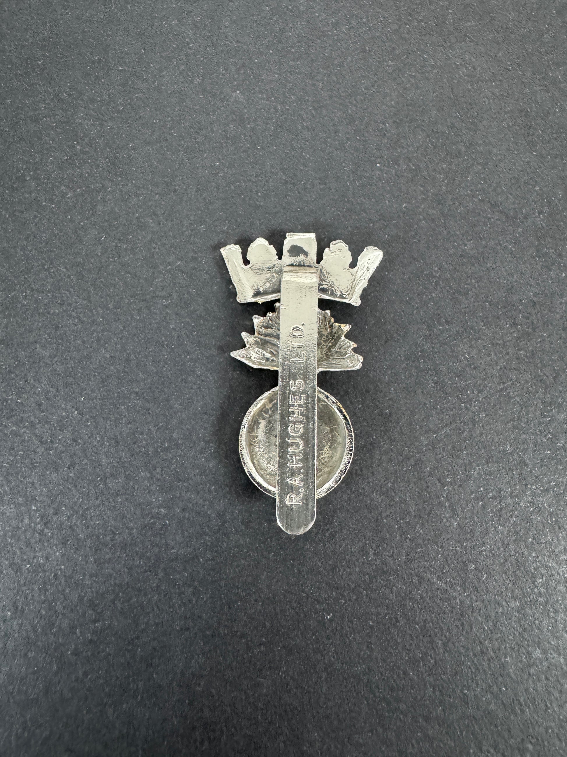British Army Royal Irish Fusiliers Anodised Staybrite Cap Badge RA HUGHES – An original and scarce other ranks cap badge o...