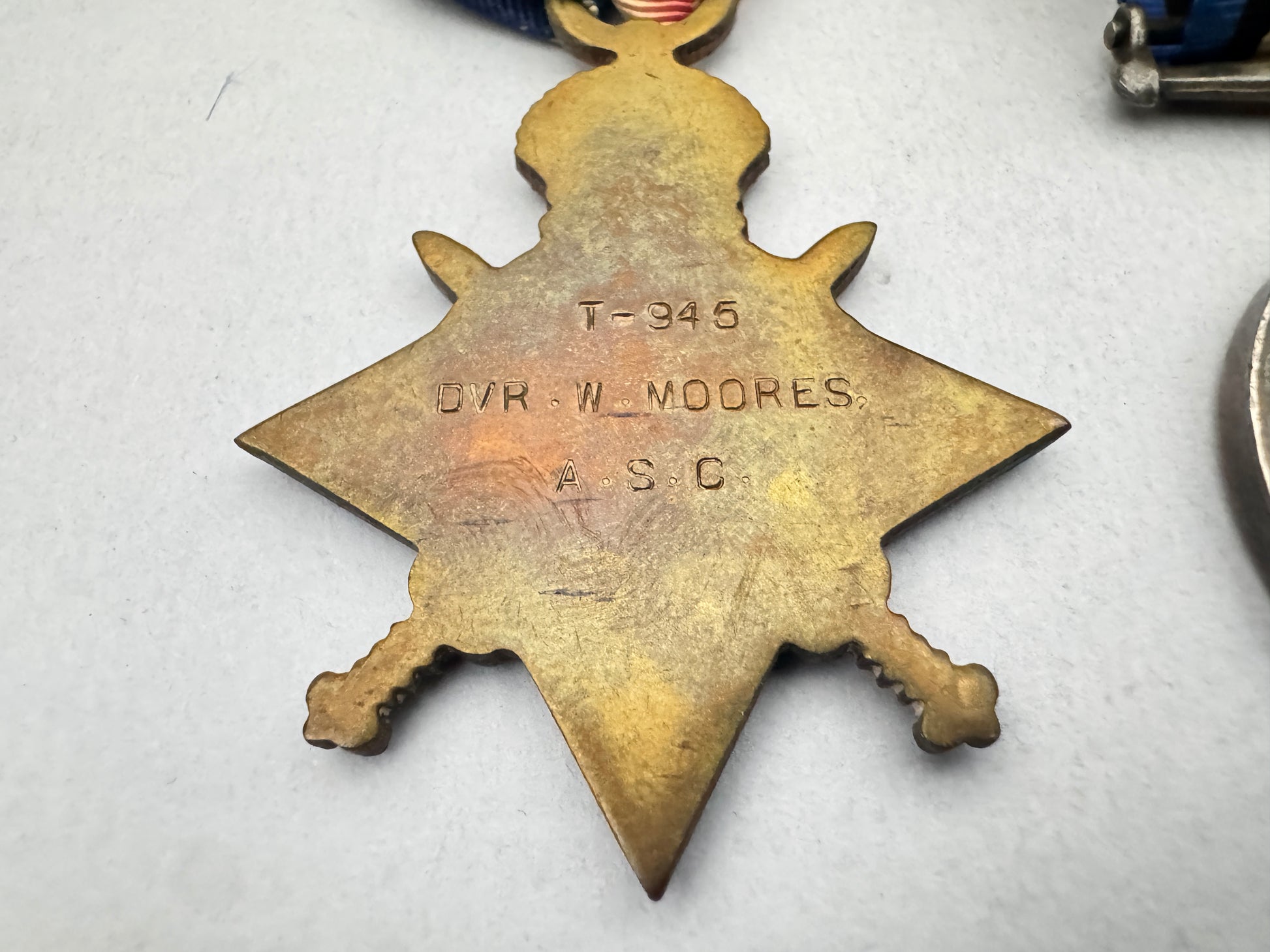 Star-shaped metal badge with engraved text on a white background