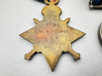 Star-shaped metal badge with engraved text on a white background