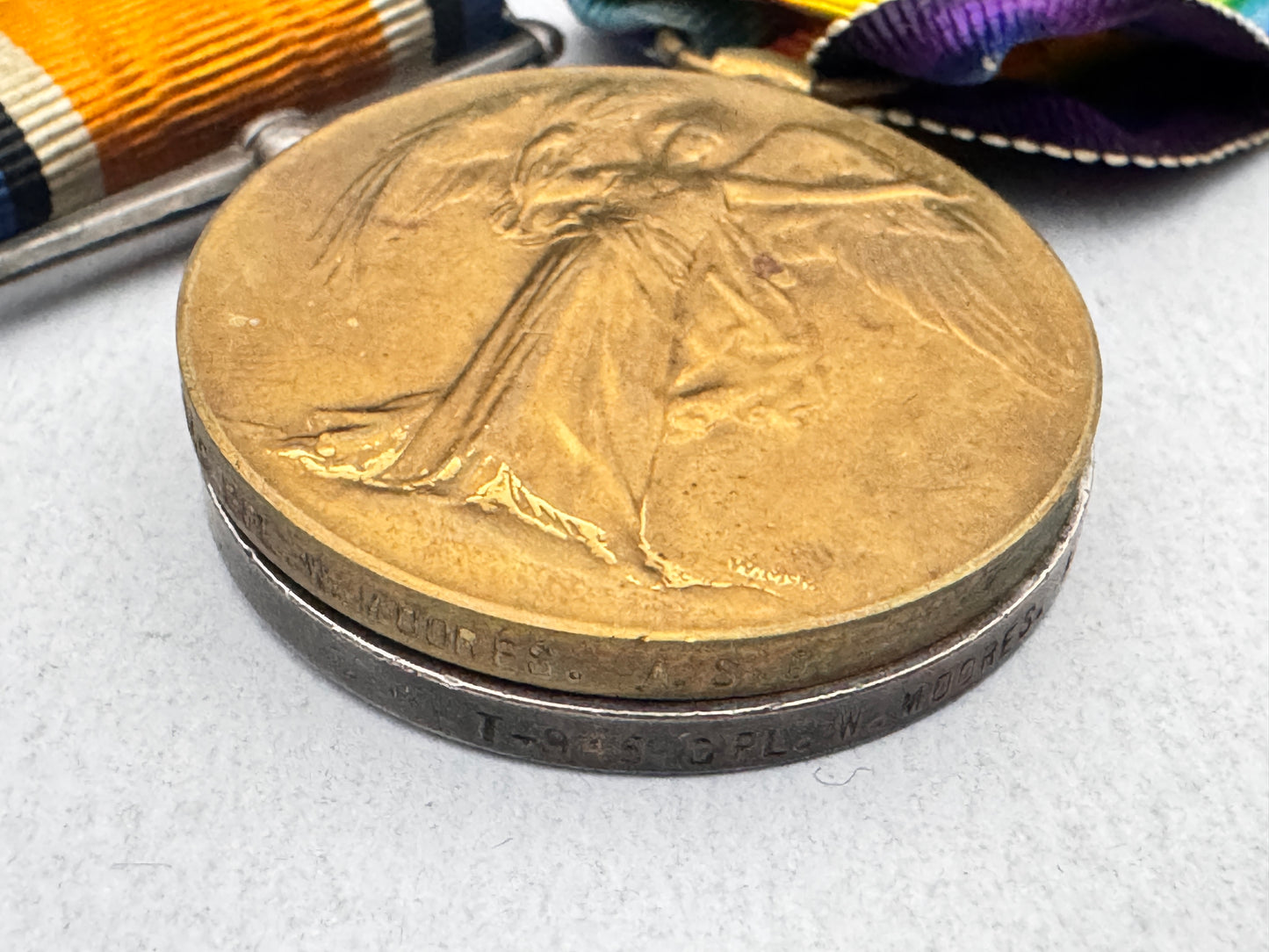Bronze medal with a figure in a flowing dress on a white background