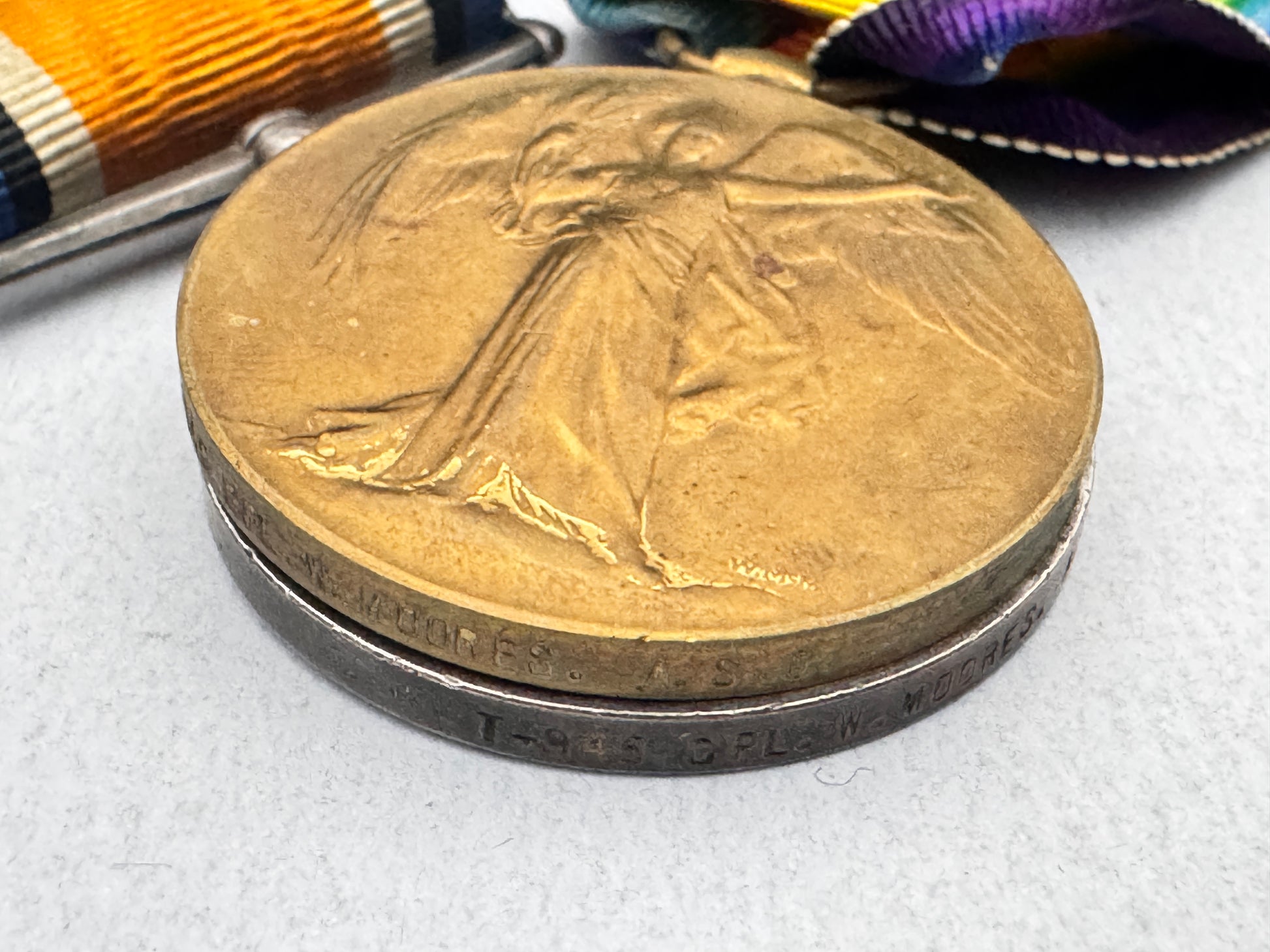 Bronze medal with a figure in a flowing dress on a white background