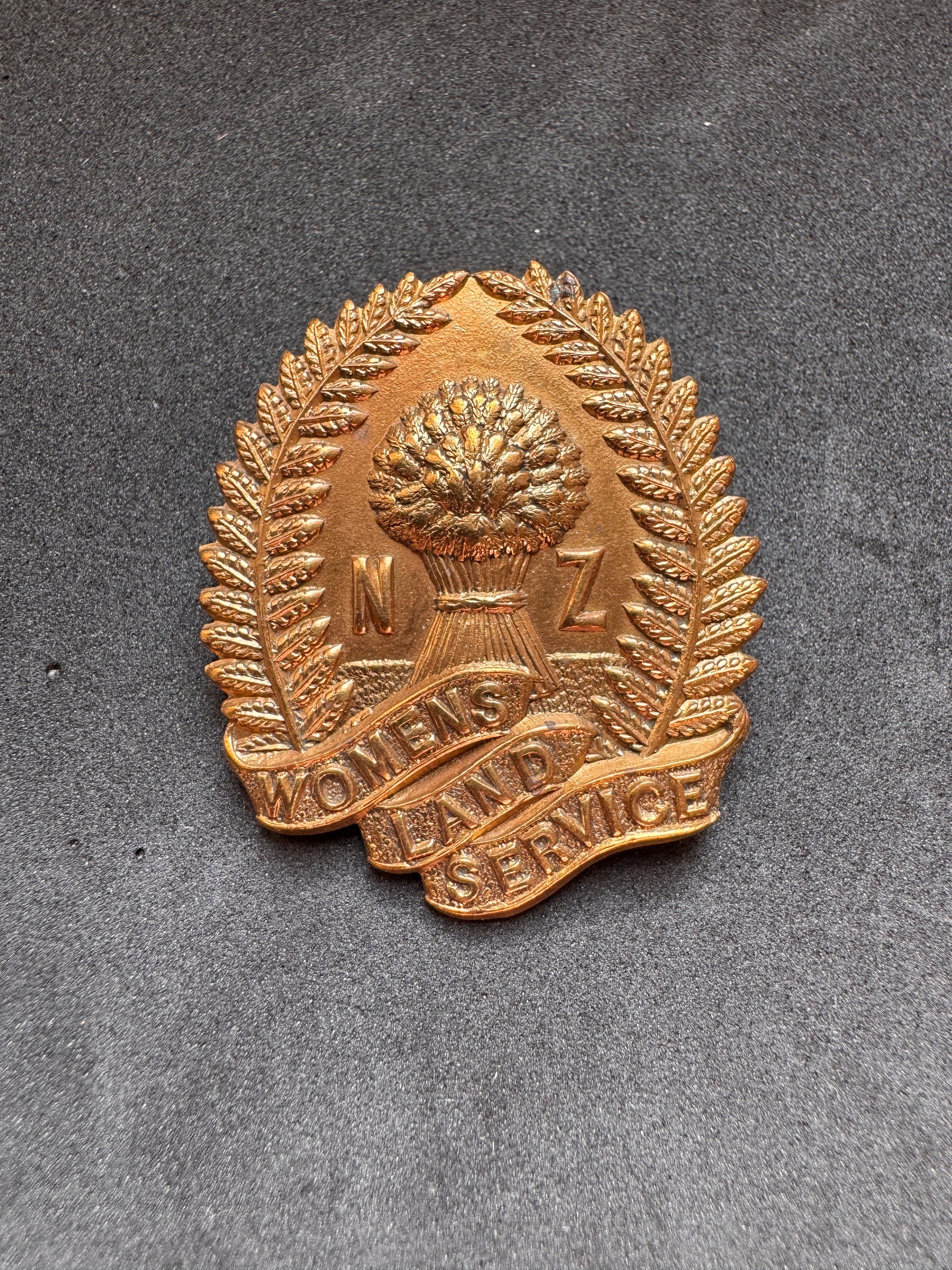Photo 1 of WW2 New Zealand Women's Land Service Cap Badge - collectible militaria item