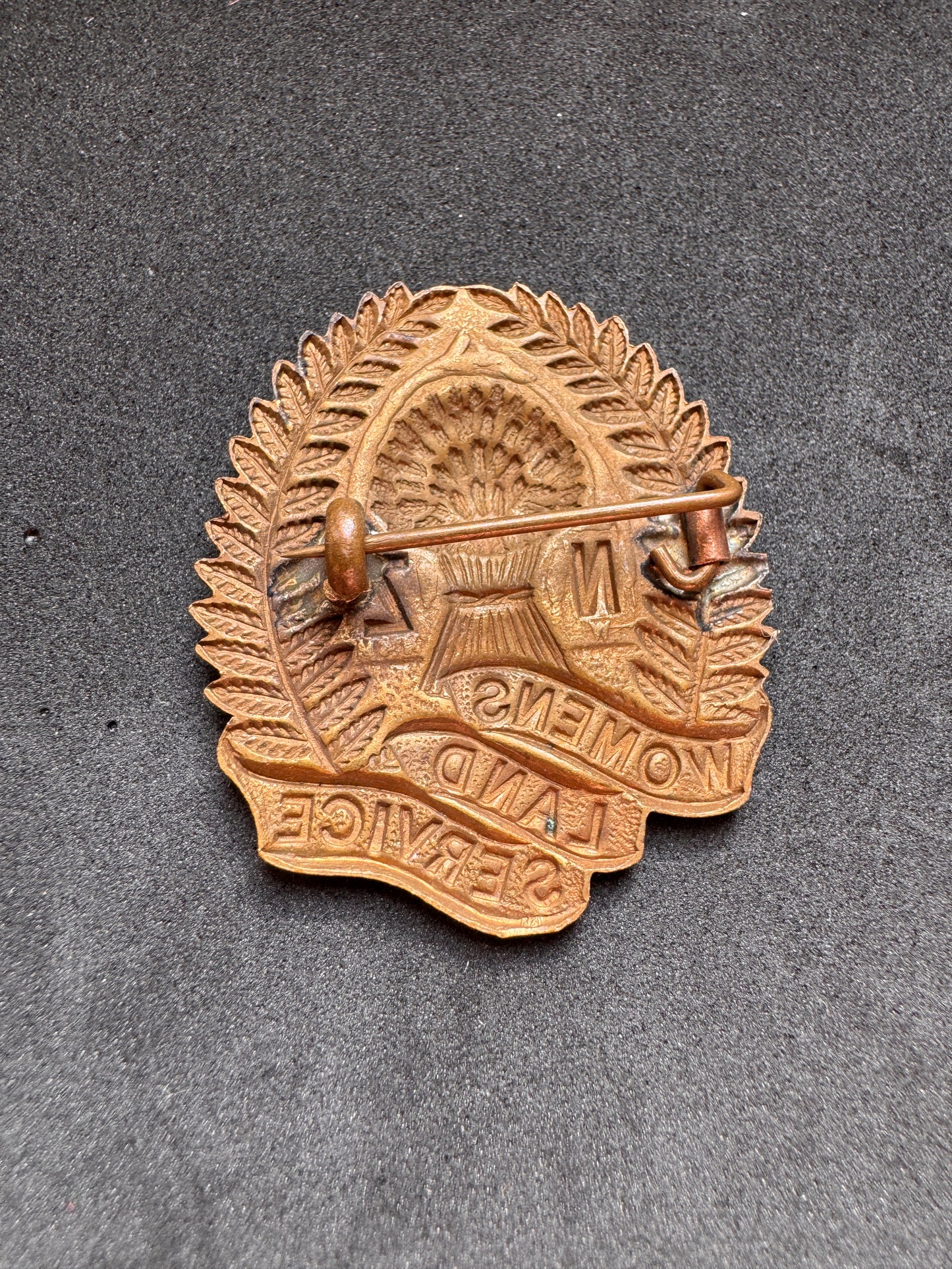 Photo 2 of WW2 New Zealand Women's Land Service Cap Badge - collectible militaria item