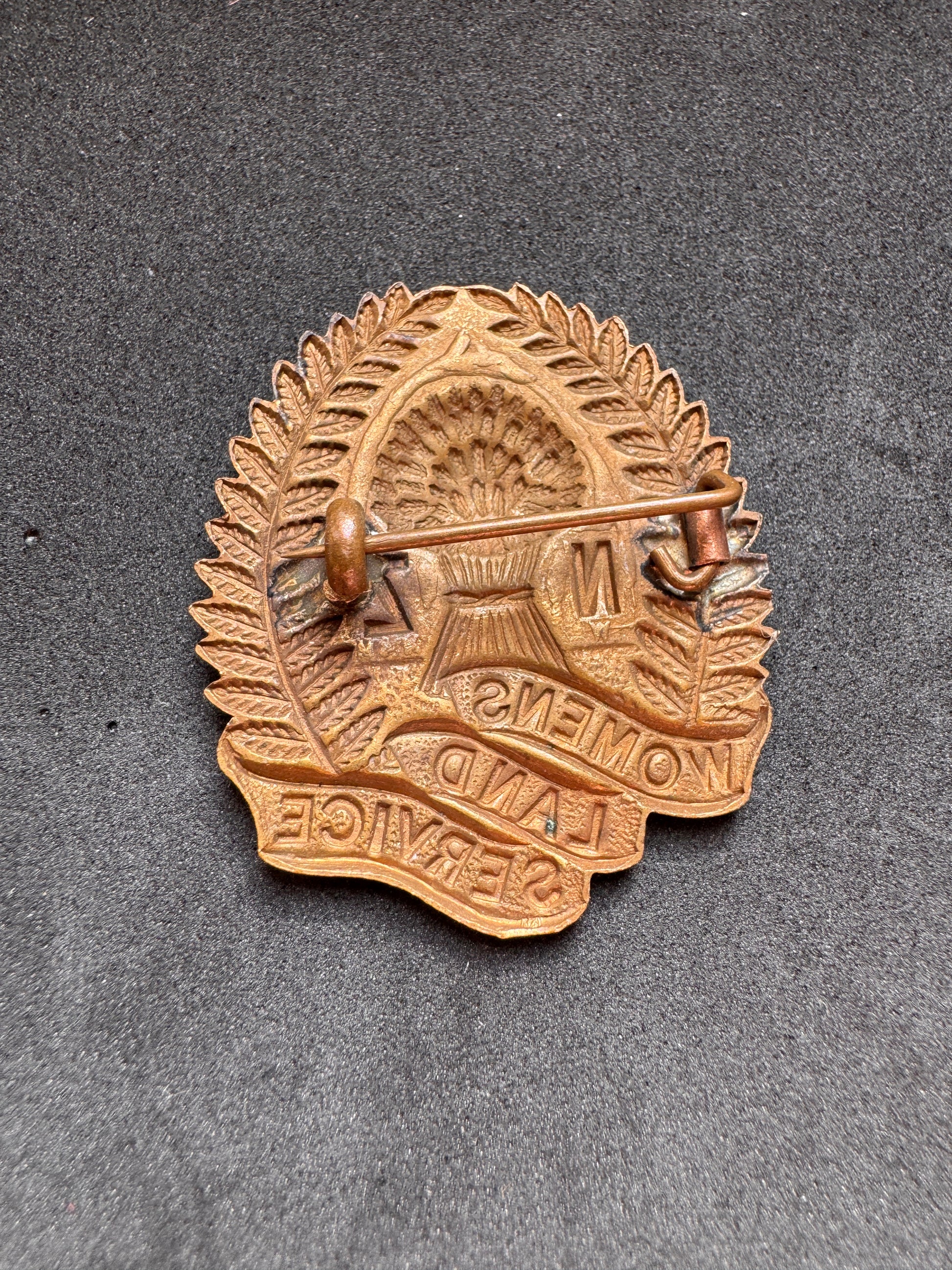 Photo 2 of WW2 New Zealand Women's Land Service Cap Badge - collectible militaria item